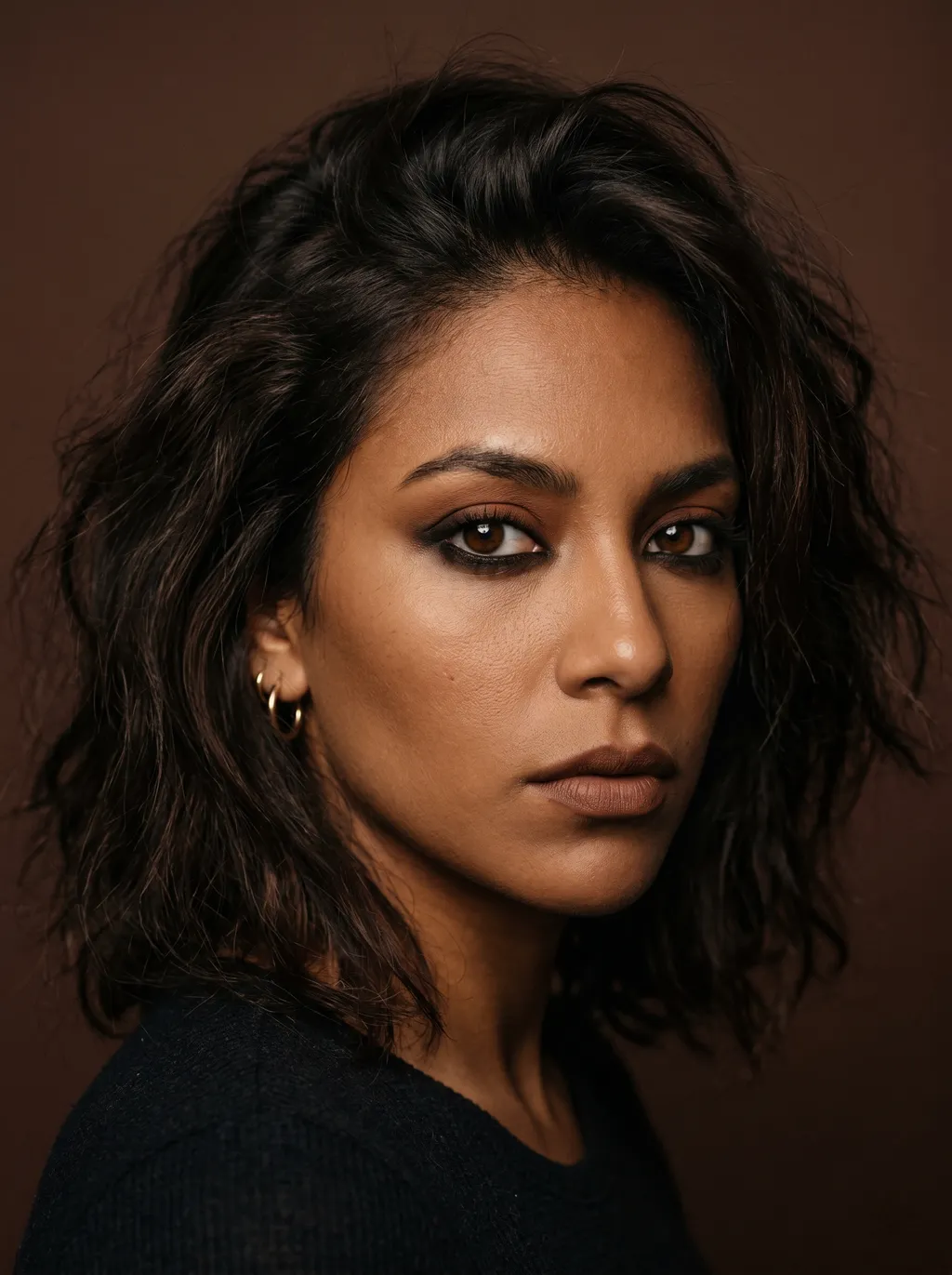 Grunge smoky eye with kohl base, burnt sienna lid, and warm near-black depth on Dark Autumn coloring