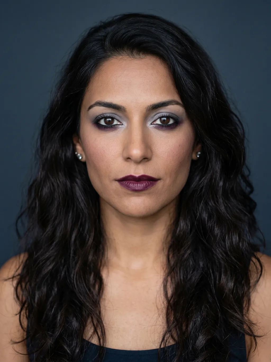 Reverse smoky eye with quiet pewter upper lid and jewel plum lower lash emphasis on Dark Winter coloring